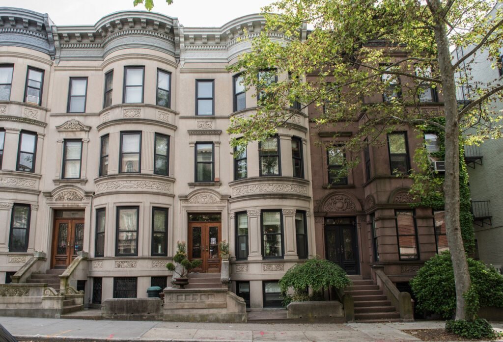 Historic brownstone buildings in New York City requiring facade repair and restoration