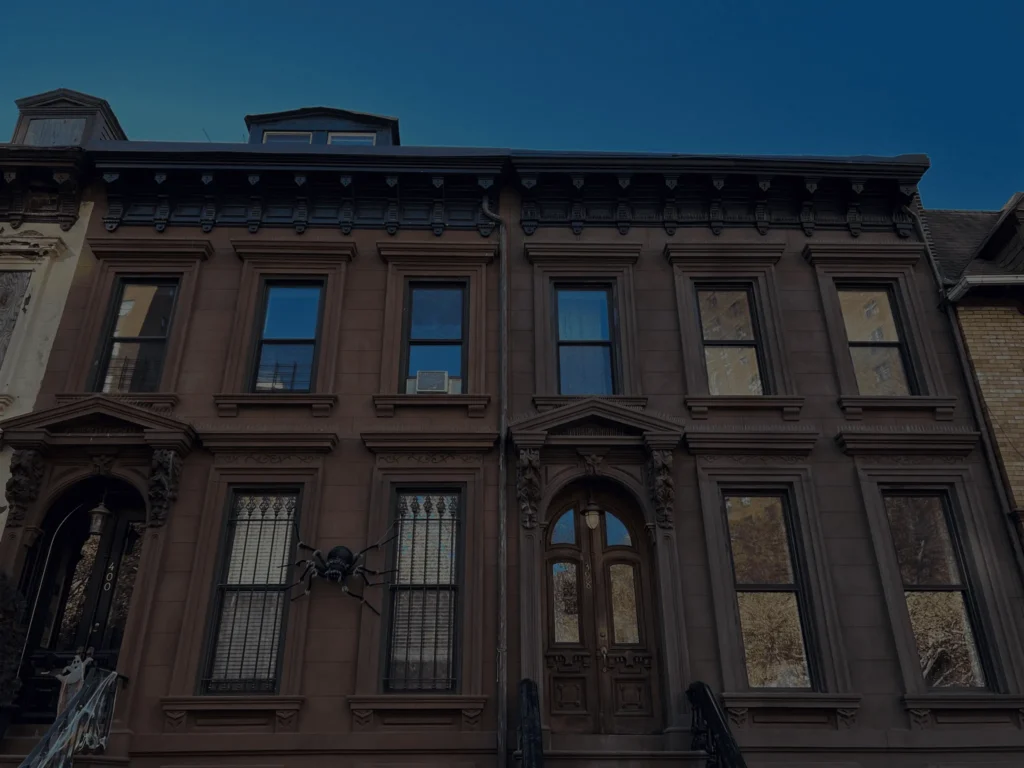 Skilled masonry contractor applying mortar to brownstone steps in Manhattan