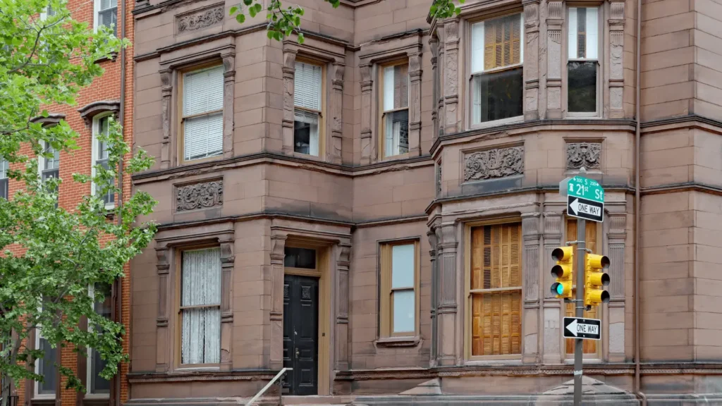 Traditional brownstone exterior with large windows and restored brickwork.