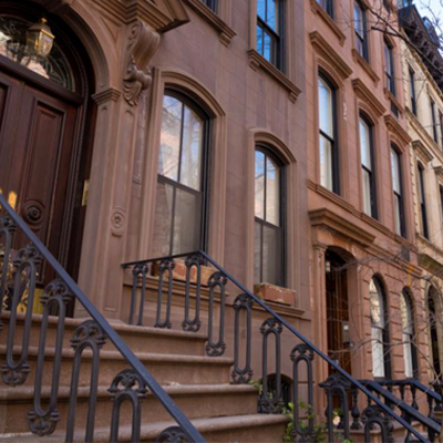 Restored historic brownstone facade and stoop after paint removal and waterproofing