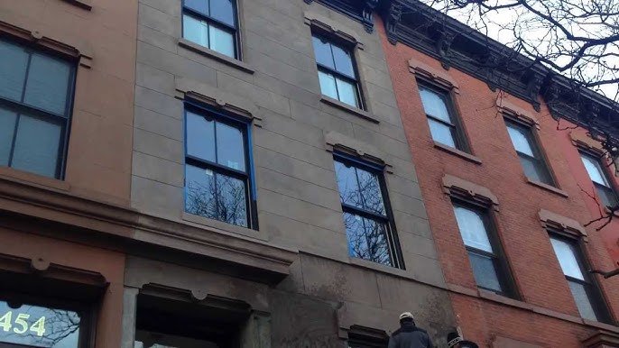 Historic stone facade restoration and parapet wall repair on a row house in White Plains, NY